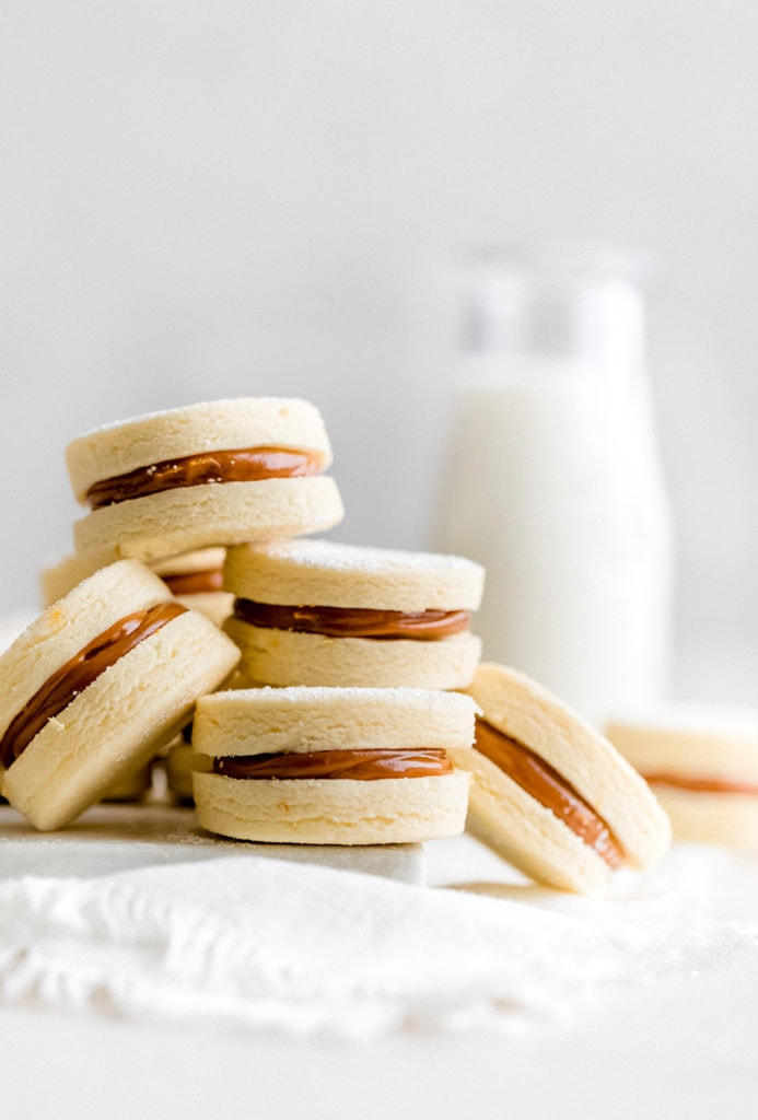 Learn how to make traditional alfajores at home with this easy recipe. These melt-in-your-mouth, dulce de leche filled cookies, are a popular dessert throughout Latin America.