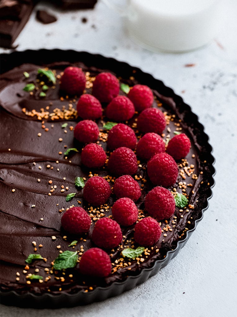 No-Bake Chocolate Tart topped with fresh raspberries.