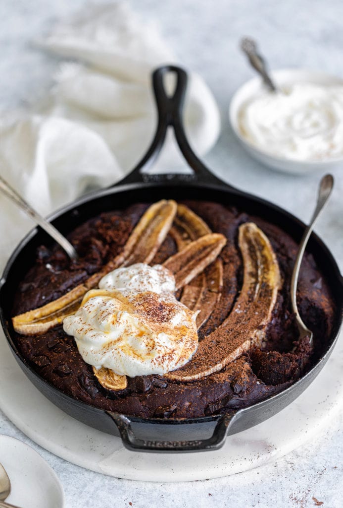 45 degree angle of chocolate skillet banana bread with spoons