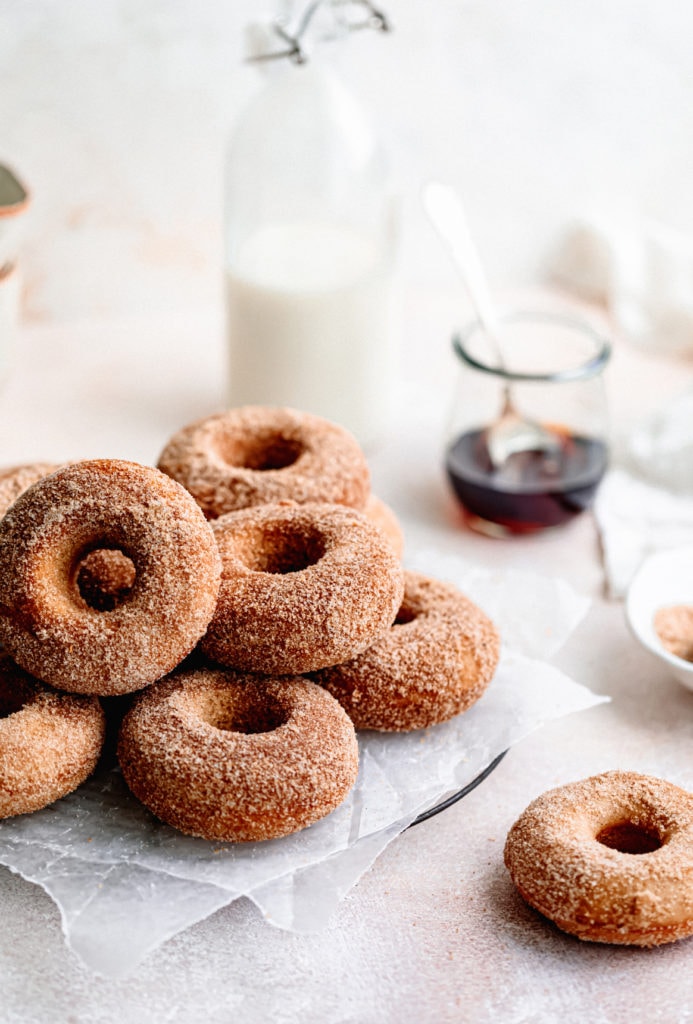 Homemade baked apple cider donuts are the perfect fall treat. Covered in browned butter and cinnamon sugar and topped with warm maple.