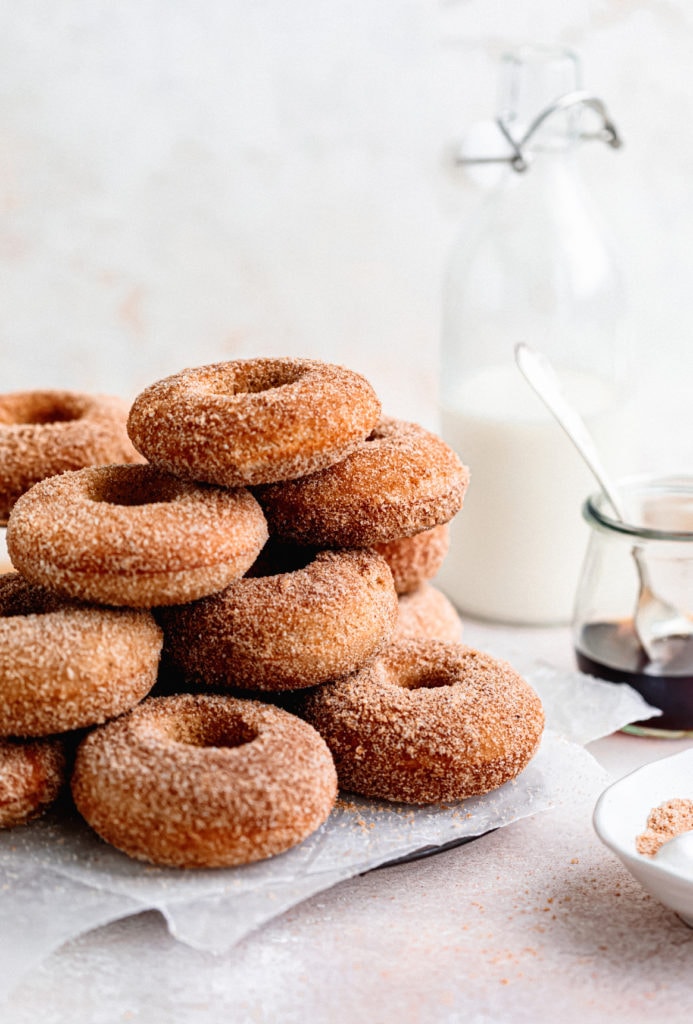 Homemade baked apple cider donuts are the perfect fall treat. Covered in browned butter and cinnamon sugar and topped with warm maple.