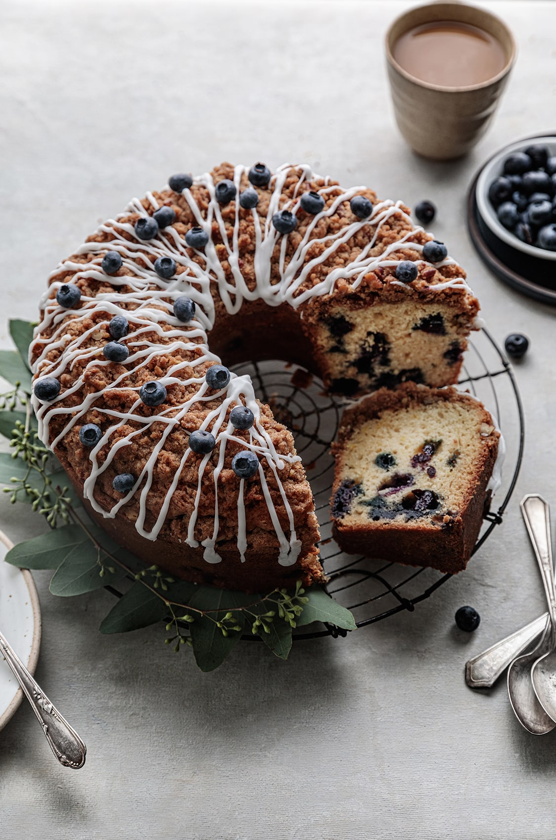 Classic Blueberry Coffee Cake  topped with a buttery pecan streusel and served warm, fresh out of the oven.
