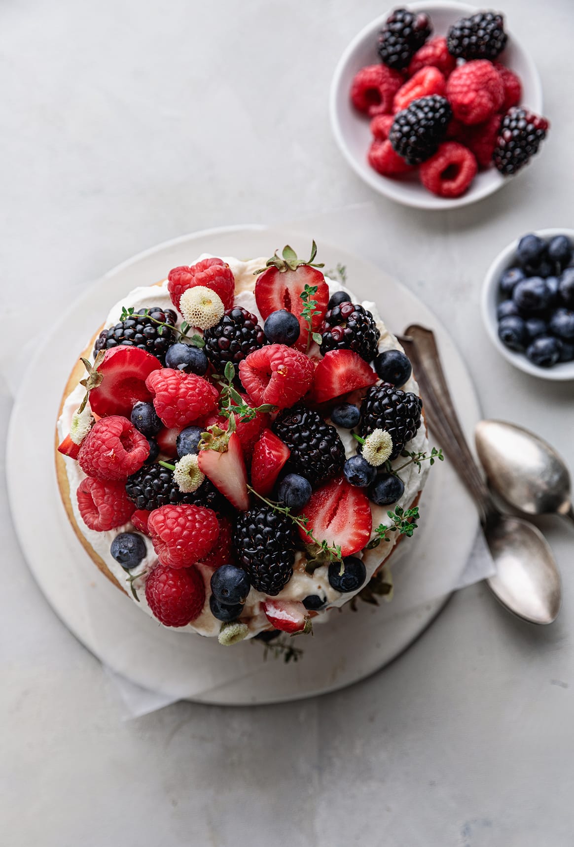 Delicious and easy to make Gluten-free Berries and Almond Cake made with almond flour and topped with maple whipped cream and seasonal berries.