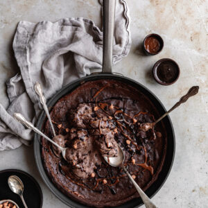 Triple Chocolate Dutch Baby with ice cream and syrup
