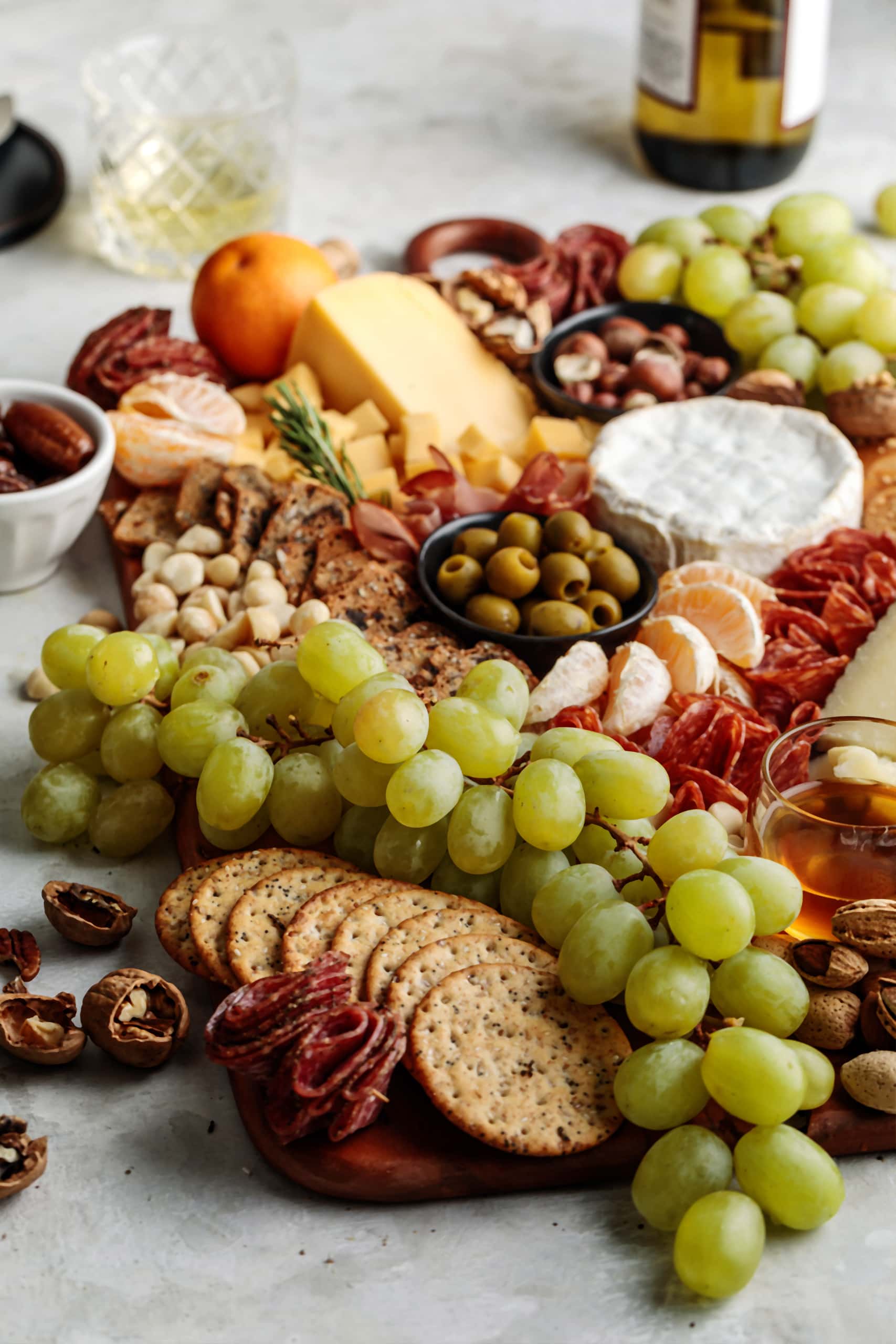 How to build an easy and impressive Winter Cheese Board featuring seasonal fruits, nuts, olives and a variety of cheese and charcuterie.