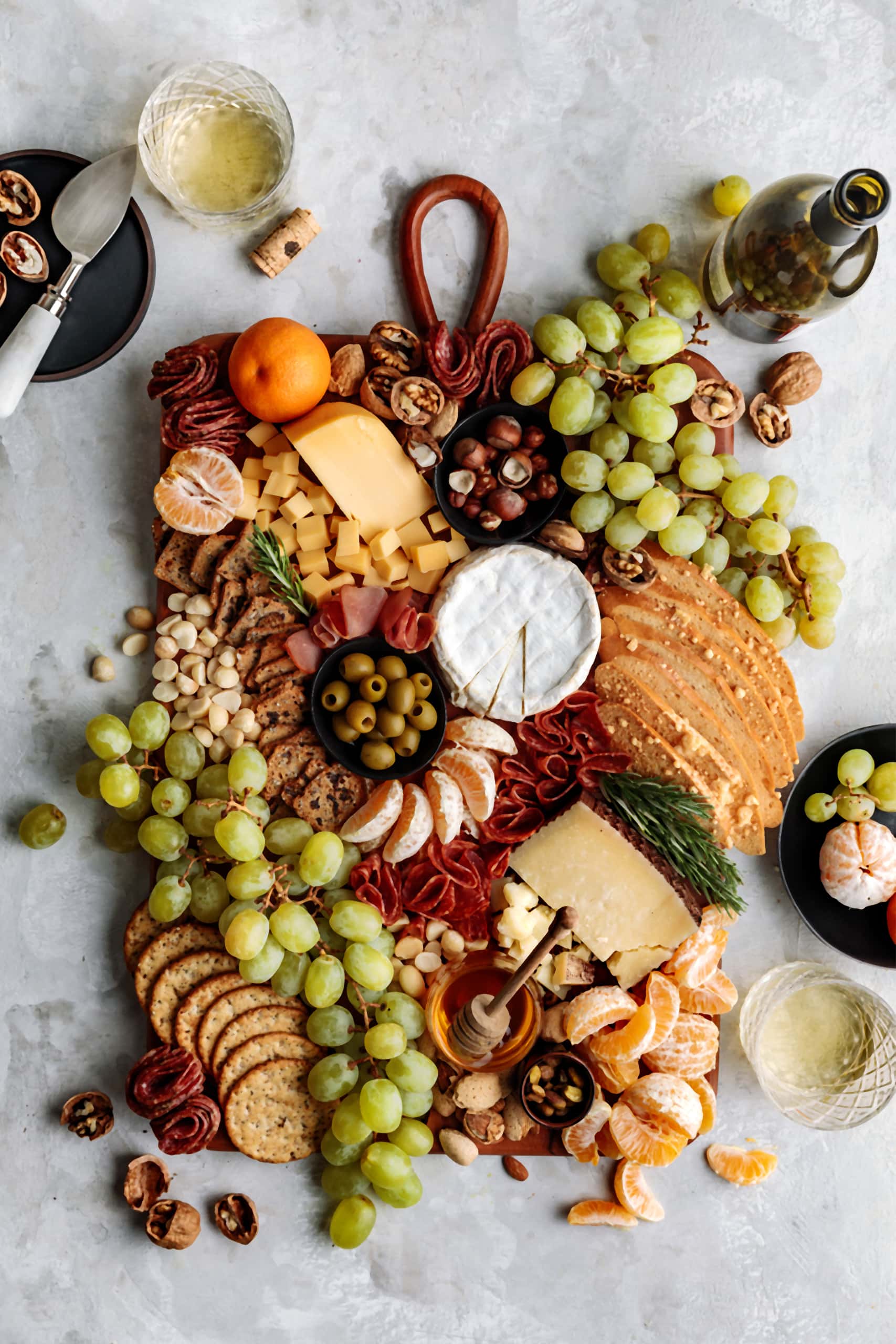 Easy and impressive Winter Cheese Board featuring seasonal fruits, nuts, olives and a variety of cheese and charcuterie.