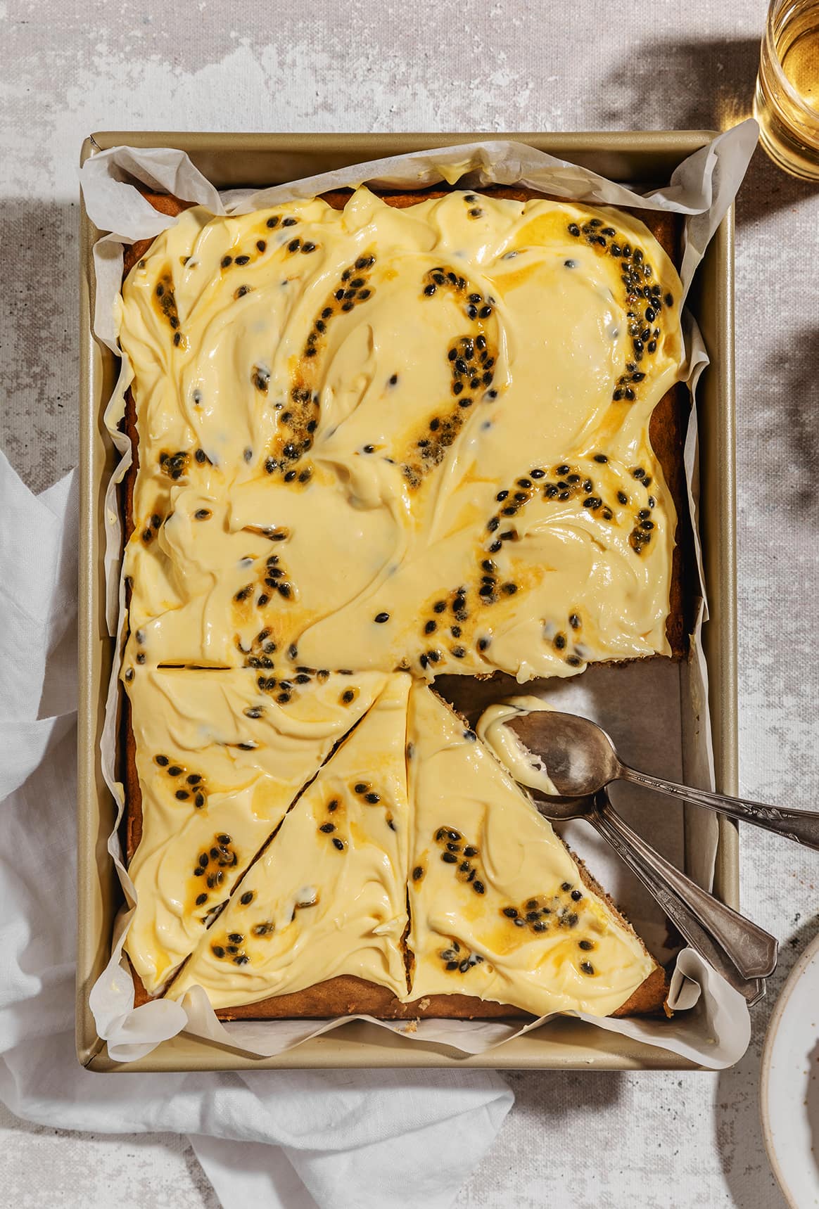 sliced peanut butter banana bread with passion fruit frosting
