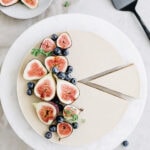 coconut cream tart with a salty pretzel crust topped with sliced figs and blueberries.