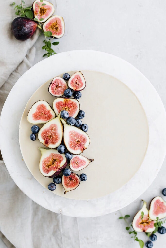 coconut cream tart with pretzel crust topped with sliced figs and blueberries.